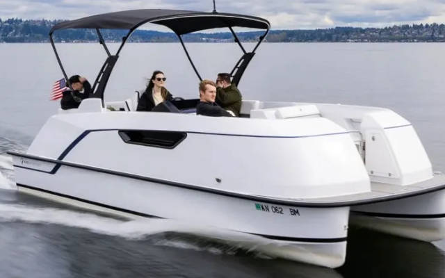 Pure electric pontoon boat cruising its native Puget Sound
