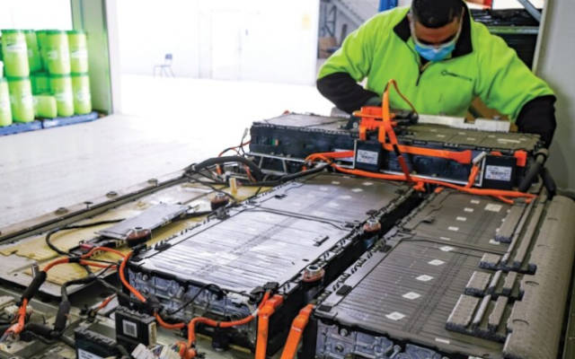 technician inspects used EV battery